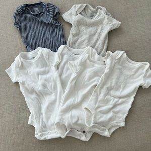 Carter’s lot of newborn onesies in white, navy stripe and solid grey.